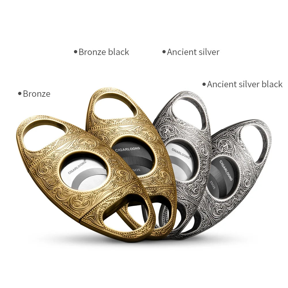 Three cigar cutters in bronze, ancient silver, and ancient silver black on a white background.
