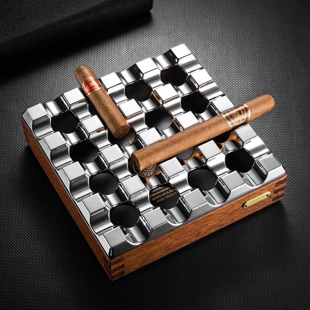 Cigar humidor with two cigars on a dark surface