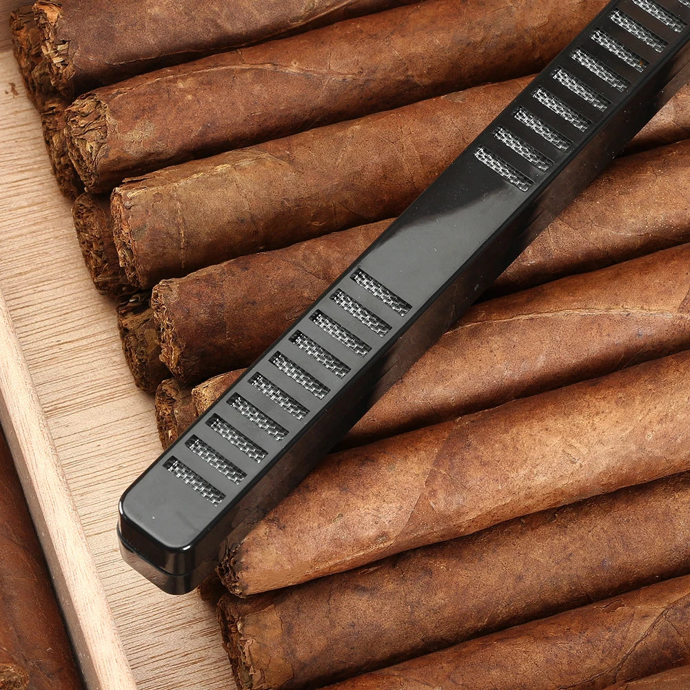Cigar cutter on a wooden surface with cigars
