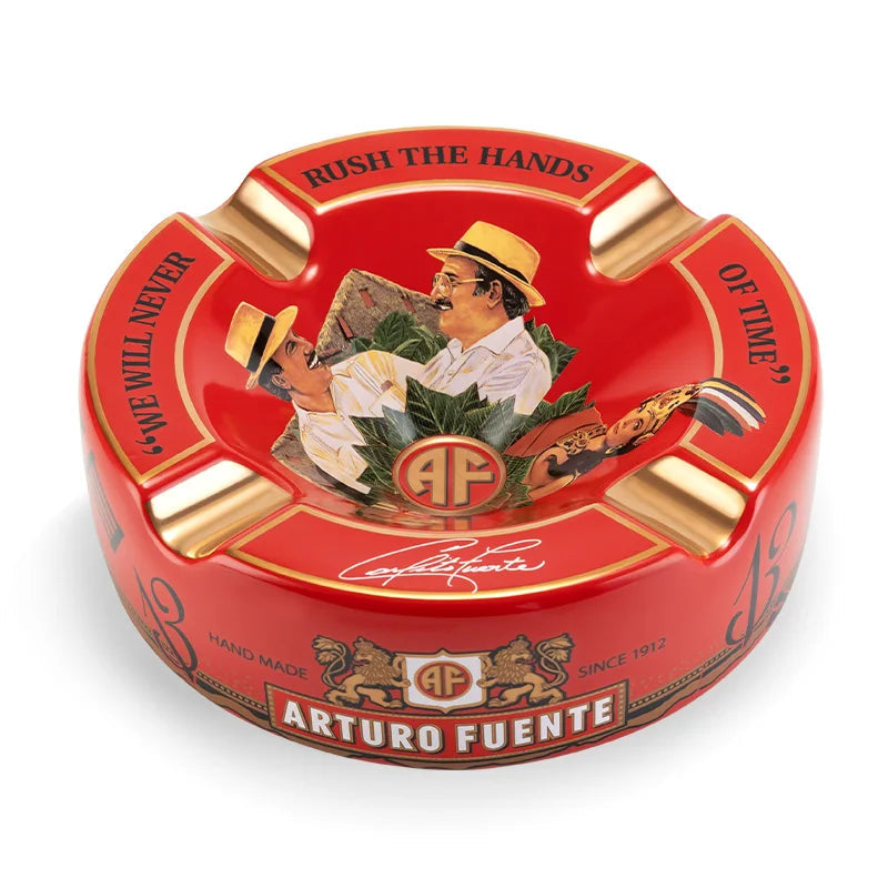 Red Arturo Fuente cigar ashtray with a portrait of a man smoking a cigar, on a white background.