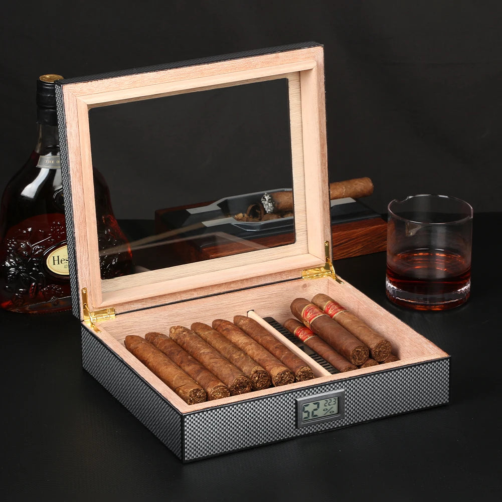 Cigar humidor with cigars, a glass of red wine, and a bottle of Hennessy on a dark background