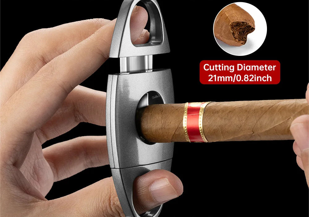Cigar cutter with a hand holding a cigar, showing the cutting diameter, on a black background.