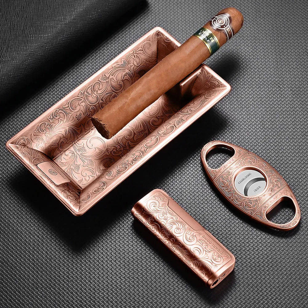 Cigar with a humidor, cutter, and lighter on a textured surface