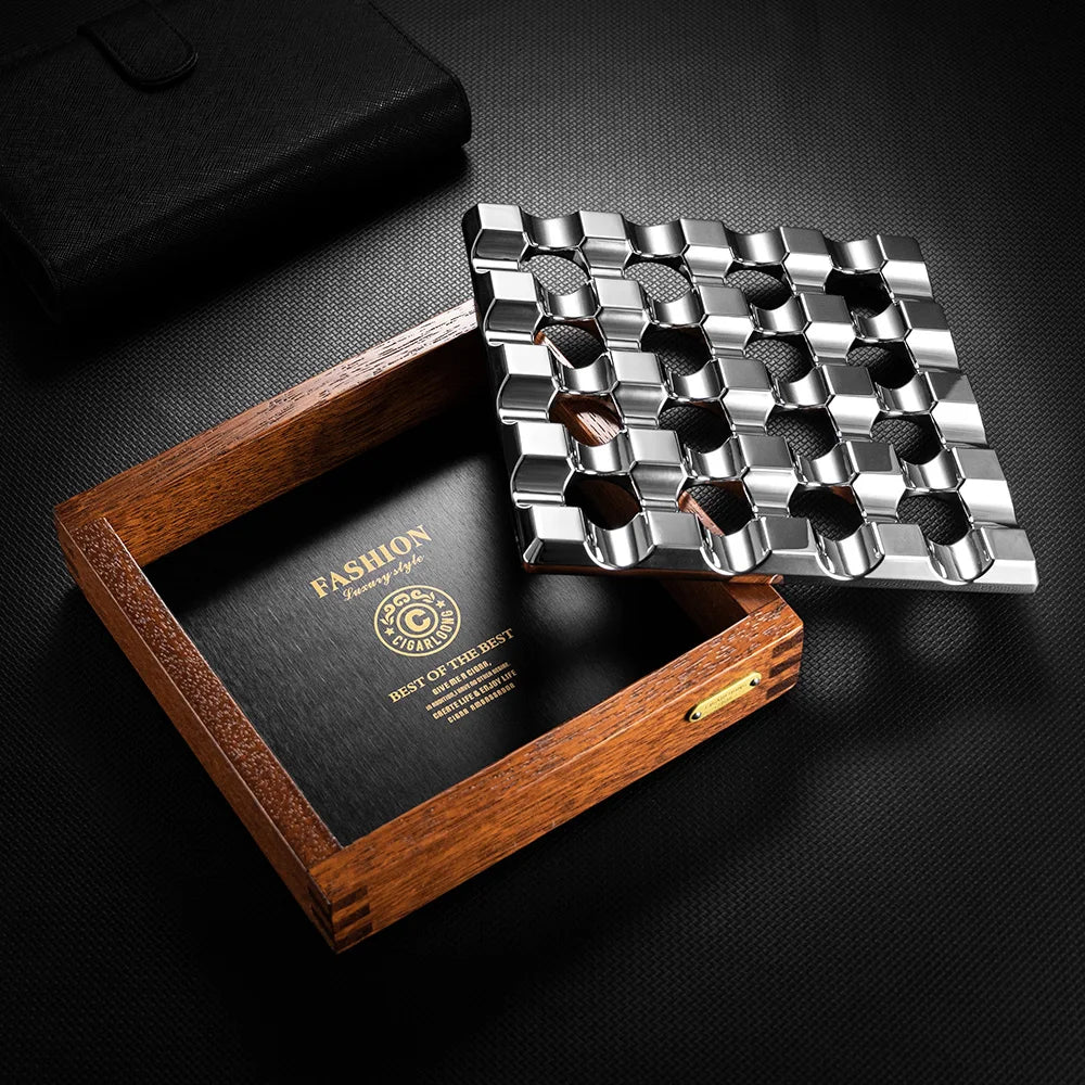 Metallic grill tool set with wooden box on a dark surface