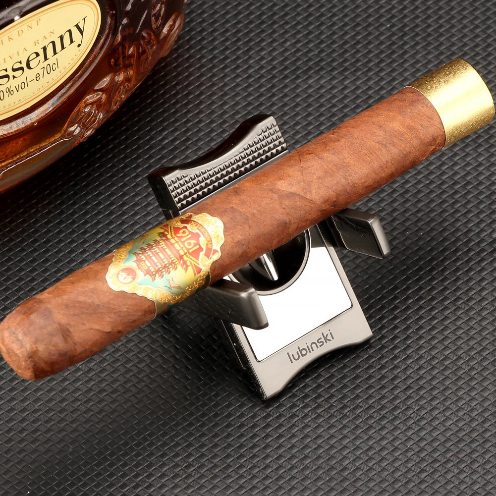 Cigar on a silver cutter on a textured black surface