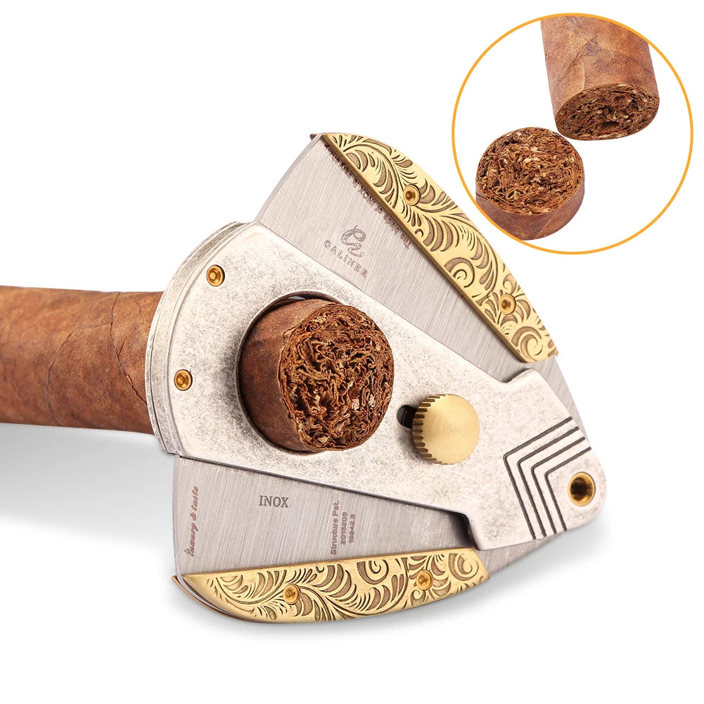 Cigar cutter with decorative gold accents and close-up of cut cigar ends on a white background