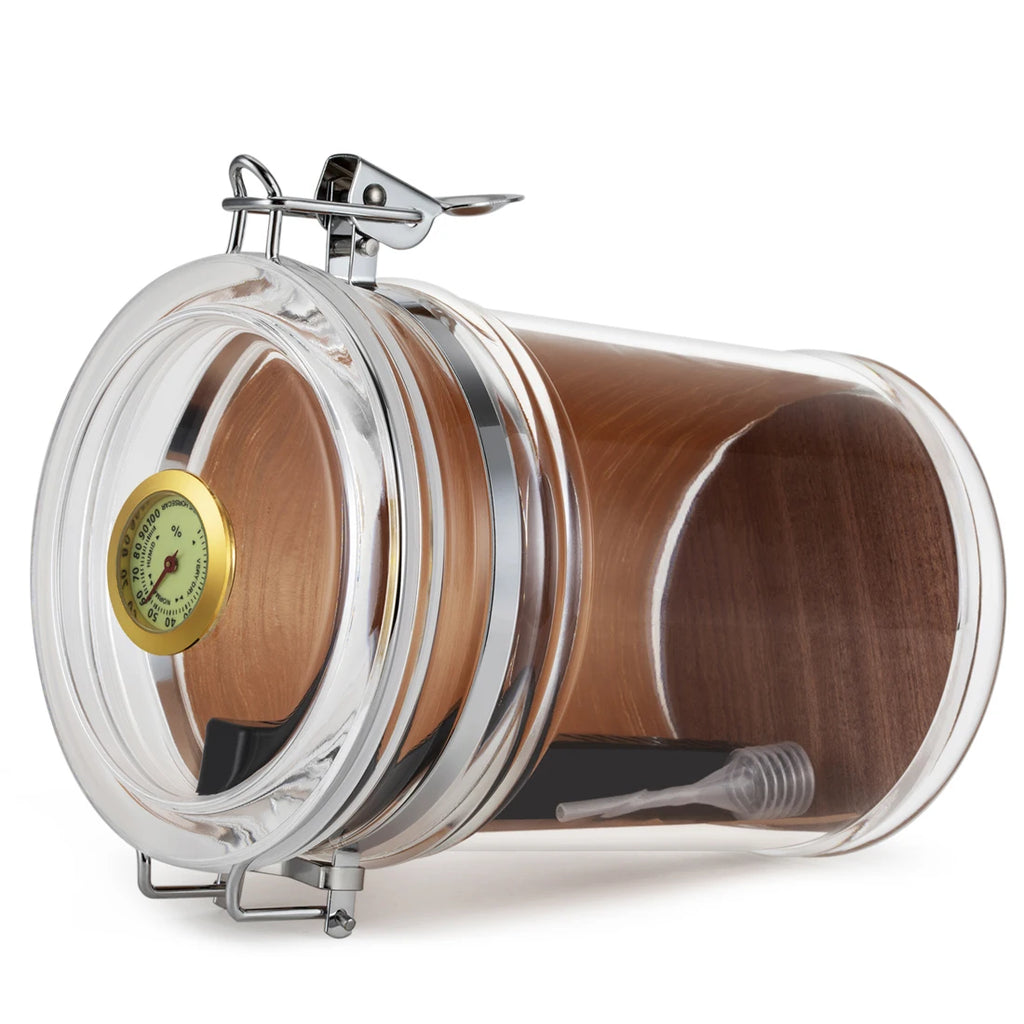 Glass jar humidor resting on its side.