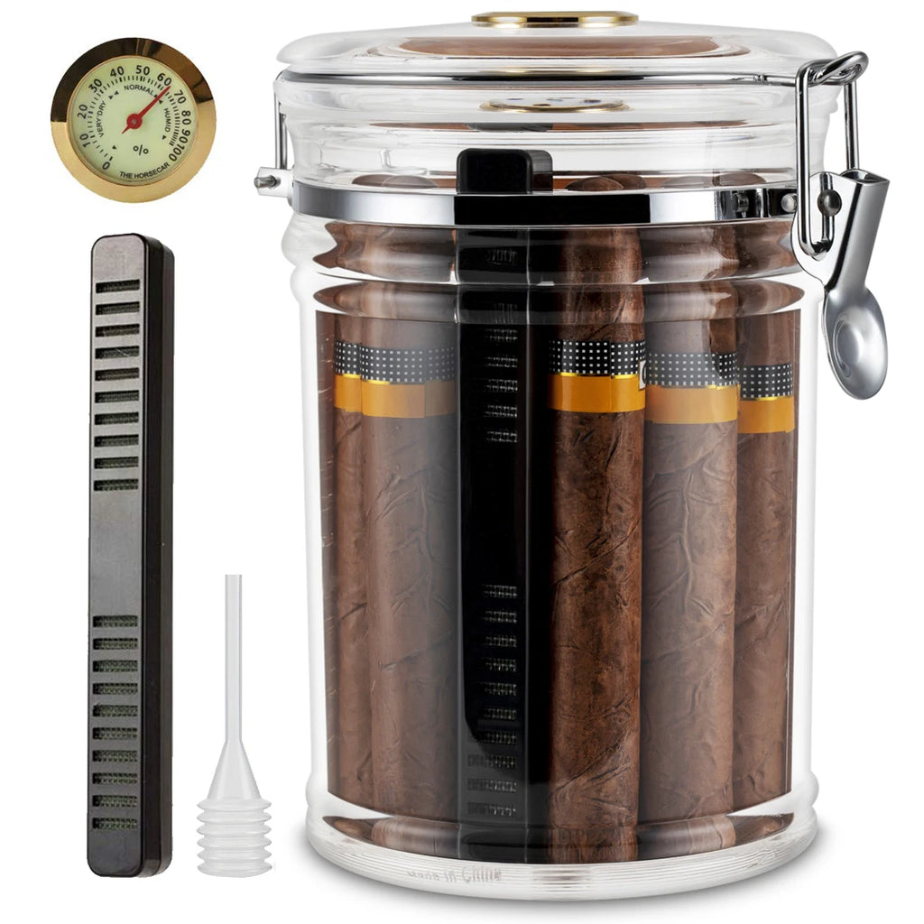 Glass jar humidor with cigars, humidifier, and hygrometer on a white background.