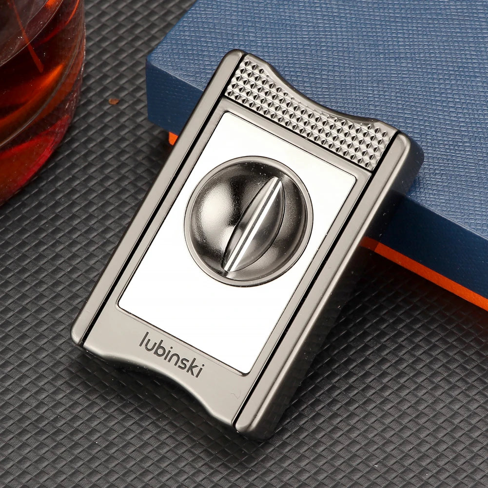 Silver cigar cutter on a textured surface