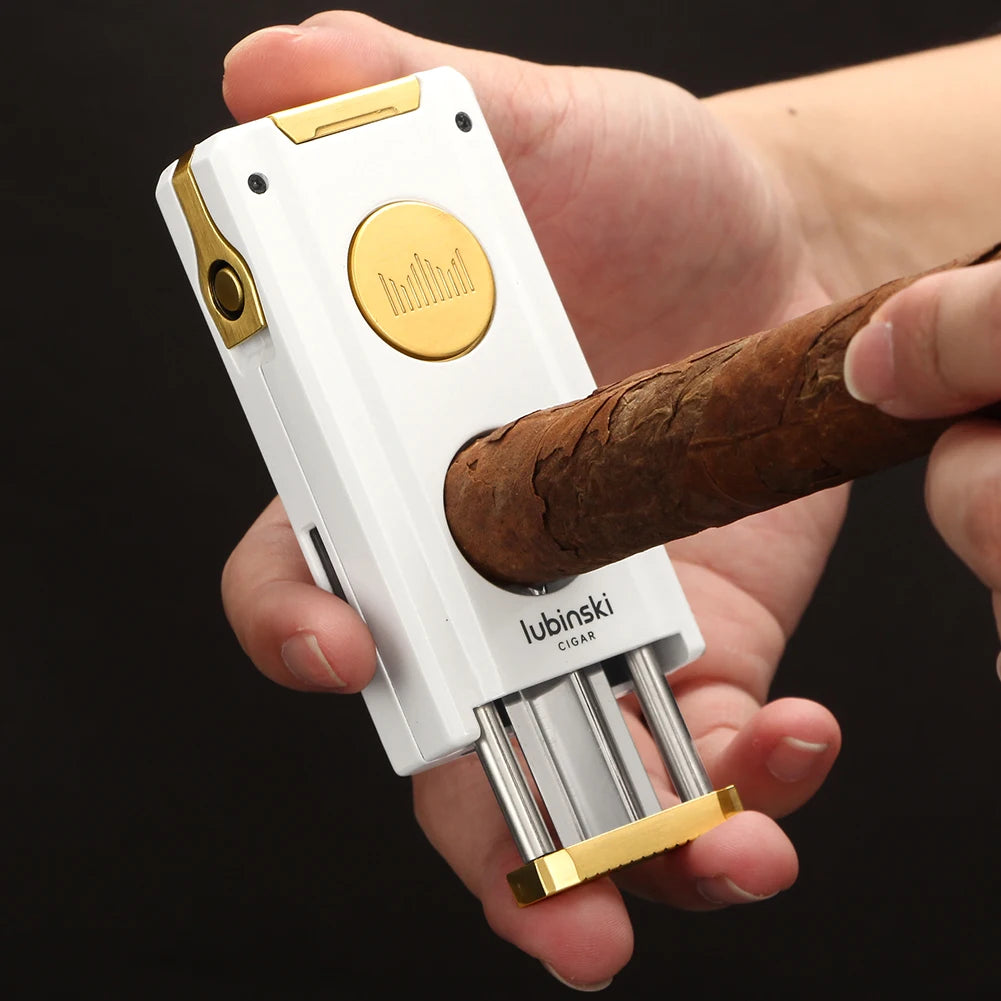 White and gold cigar lighter using v cutter on cigar.