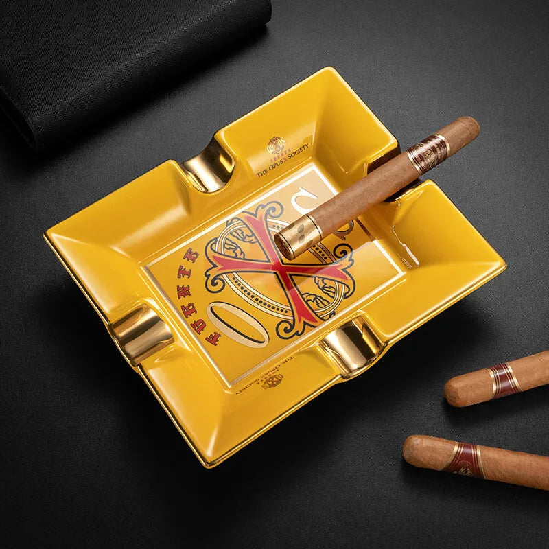 Yellow cigar ashtray with cigars on a black background